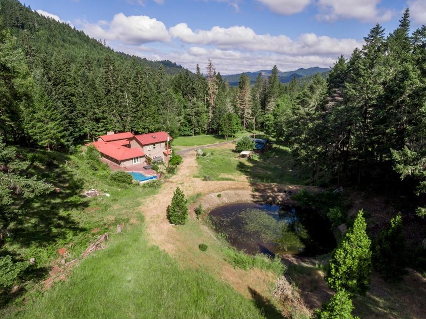 Magnificent 53.25 Acres of Oregon Dream Property, offering literally everything a Buyer looking for Peaceful Rural Living could want. A Fantastic 4 Bed, 4 Bath Tuscan-Style Contemporary Villa with a Lovely Floor Plan & Open-Air Courtyard. Huge Living Room with Soaring Ceilings & Fireplace, Dining Room, & Wonderful Country Kitchen. Spacious Bedrooms & Large Laundry/Utility Room with Basin & Cabinetry. Separate Upstairs Guest Suite or an Alternative Master Bedroom with Private Deck & Beautiful Views. Full Basement offers tons of storage. Huge Rear Deck with a Lovely In-Ground Pool & Hot Tub. Finished Two-Car Garage with lots of Storage. A very nice 36'x30' Barn with Stalls, Woodshed, Tool Shed, Chicken Coop, & more. Spectacularly Beautiful Land, offering Level to Rolling Terrain, & a mix of Meadows, Pastures & a Mature Forest with Marketable Timber. Two Creeks with Salmon/Steelhead Populations, & a Pretty Pond. Backs directly to BLM for great Hiking, Hunting, & more. Secluded & Special!