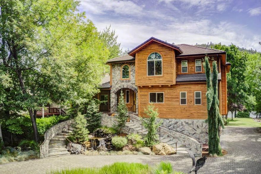 Welcome to a spectacular Rogue River front property. Custom built & located 80 feet off the river offering incredible views. Encompassing the perfect blend of woodwork, stonework, and artisan touches. Easy riverbank frontage and outdoor living on the deck with a stone fireplace, built in BBQ, sink, refrigerator and ice maker. Master suite is on the main level, master bath features beautiful Labradorite counters, oversized rock shower & more custom touches. The home is 3904 sqft, 4 bedrooms, 3 & 1 half bath. Great room and fireplace with two sculpted bronze bear cubs climbing log poles. Beautiful kitchen with a dumb waiter, Wolf range oven, second oven, granite island & prep sink. Additional bedrooms are fantastic and second master with a shower & jetted claw foot tub. As you enter the gated entry you will notice a putting green, very large RV garage complete with full hook ups & plenty of room for both your RV and shop area. This is the ultimate Oregon River Front property!