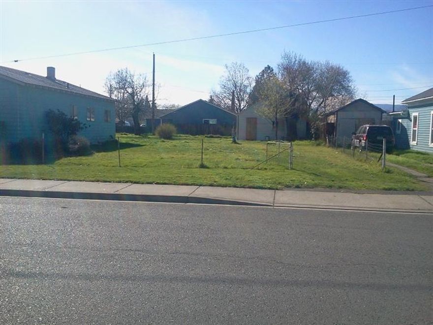 .14 acre lot in established Medford neighborhood. Garage on property. Buyer to due diligence all the city on building & redeveloping property. All access. in middle of property will be offered off old well on property filled in 50 years ago.