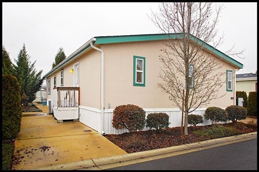 A beautiful home in Cobblestone Village 55 and over manufactured home park. This is a highly sought after 55 and over community located just one mile from Jacksonville. This home includes vaulted ceilings, living room and separate family room. 3 bed, 2 bath floor plan with 1512 sq ft, light and spacious and a beautiful master suite. Very desirable location with beautiful surrounding views of the West Hills. A must tour home!