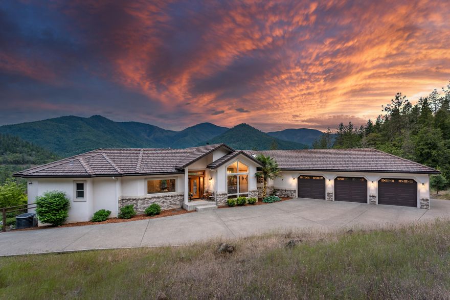 Located minutes from town & the Applegate River, this custom home on 20+ acres, backed by hundreds of acres of BLM, is distinguished by the rare combination of seclusion & convenience.  Built in 2002, this 4576sf residence boasts breath-taking views from every room, large light filled windows & natural wood accents. Spacious main floor includes family room, home office, dining room, half bath & open great room complete w/ well-appointed Kitchen, large pantry & glass doors that lead to the expansive deck overlooking the mountains, plus the main floor Master includes a private deck & spa-like ensuite bath ensuring homeowners a private place to relax. Having guests? You'll love the lower level complete w/ 2 guest rooms, bathroom, bonus room w/ wet bar, plus a theater/game room, 14X23ft workshop & 2 storage rooms! Outside you'll find a fenced yard w/ lush landscaping & water feature plus a paved driveway w/ security gate, 3 car garage, RV parking & more! Ask for the Video & Virtual Tour!