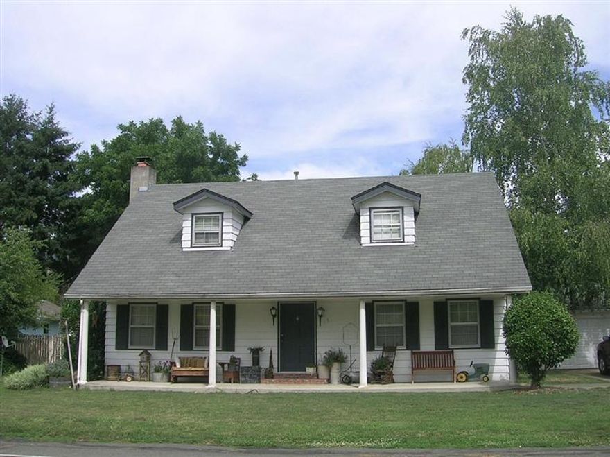 Colonial style 1900 sq. ft., 3 bedroom 2 bath on large lot, with a 2 car garage, attached workshop and covered outside storage. Huge country style eat in kitchen with lots of cabinets and tile counters, also a formal dining room. There's a fireplace in the living room. All the bedrooms are upstairs and good sized, the Master Bedroom has walk in closet. Wainscoting, chair rail, and baseboard moldings are accented with Hardwood floors and carpet. Large back yard irrigated from GPID with raised garden beds and lots of room for fun. Plenty of room for an RV and other toys.