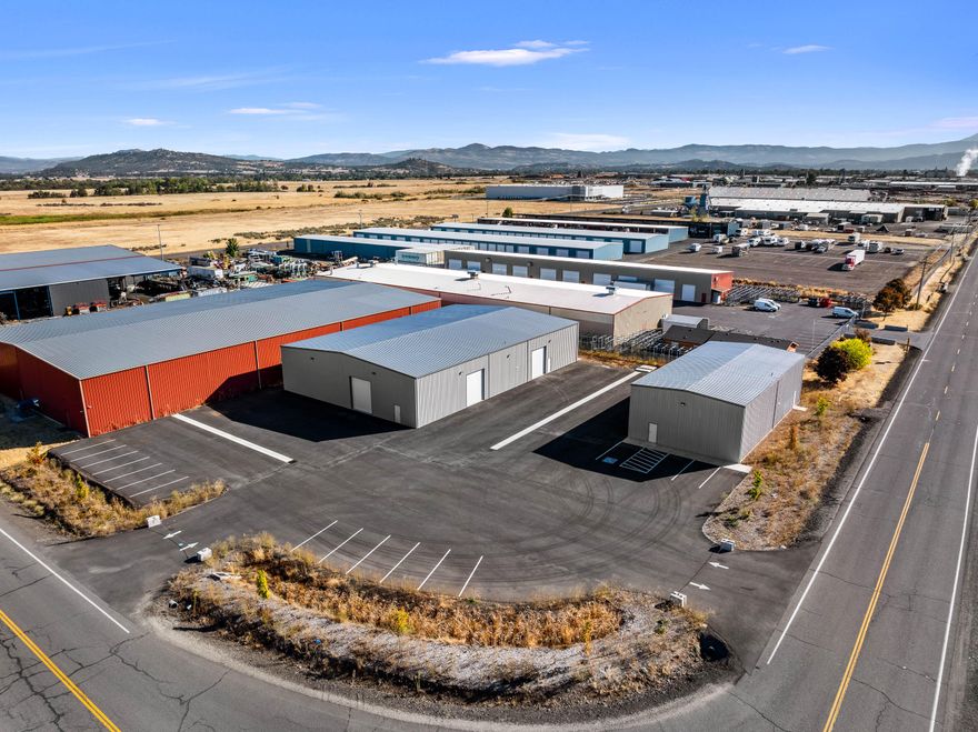 Outstanding opportunity in White City's industrial hub! This property features 2 BRAND NEW commercial buildings designed for modern industrial needs. The main 9,600 sq. ft. facility is equipped with a powerful 1,600-amp, 3-phase, 480v electrical system—perfect for heavy manufacturing, distribution, or specialized operations. A secondary 3,200 sq. ft. building with 800-amp, 3-phase, 480v power offers excellent flexibility for additional production, storage, or office use. Situated on 1.19 acres, this corner lot provides two access points from different roads, allowing excellent traffic flow for deliveries, large vehicles, and customers. The site also offers ample space for parking, loading, and yard use. Conveniently located in an established industrial area with easy access to major highways, this property is ideal for businesses looking to expand or establish operations in a brand-new, high-capacity facility in one of Southern Oregon's most active industrial markets.