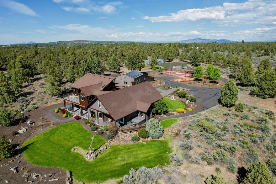 Multi-generational Compound! A short 5 min drive to the new Costco, 5 mins to Tumalo & 10 minutes to downtown Bend . This is a very private property which includes:

Main home has 4 Bedrooms & 4 Baths with Cascade Mt. Views 

One side of the home has a Master Bedroom on the ground floor with a Master Bath including a sauna with an additional bedroom upstairs and another full bathroom on the main floor.  This side of the home includes a kitchen, Gas Fireplace, dining and living area with a jacuzzi spa just outside on a private deck. The other  side of the home has Two (2) Full 1 BD - 1 Bath Suites with Full Kitchens, Bathrooms, Bedrooms & Living areas including a large deck off of the upper and lower units for true outdoor living. The detached Shop / ADU has an office/bedroom with a bathroom & kitchen. Enjoy the private setting, 7.61 acres, custom gate & fully fenced + HUGE PICKLEBALL / Sport Court with Gazebo and fire pit. Lots of RV & Toy Storage!

This property has it all!