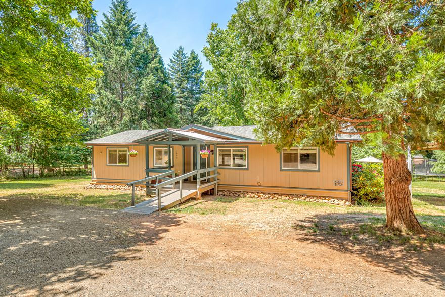 Country setting on a flat, usable .98 acre just minutes to Griffin Park and the mighty Rogue River. This adorable home features a split, open floor plan. The kitchen has been recently updated with new cabinets, granite counters and subway tile. Primary bedroom has walk-in closet and bathroom with easy, step-in shower. The covered back deck is huge and is perfect for relaxing on a summer evening or entertaining. The backyard is perfect for gardening, yard games or a cozy hammock and features apple, plum and cherry trees. The property is completely fenced and has plenty of room for parking and outbuildings for storage. The taxes for 2022 were only $970. If you are looking for the country lifestyle, close to town, this is the one for you!