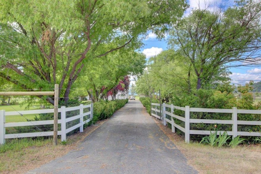 This desirable mini-farm has an exceptional well which includes a water right w/no use restrictions. Set on 3.69 flat usable acres in a rural subdivision near the Rogue River, it is surrounded by white vinyl fencing, beautiful shade trees and green lawns. The property boasts a 1,000 sq. ft. barn, a 240 sq. ft. Santa Barbara glass greenhouse, chicken coop, storage sheds and 2,500 sq. ft. of garden space w/18 of amended soil. The vineyard hosts 175 Barbera Grape vines about to mature and there are numerous fruit trees and berry bushes. Relax on your brick patio in your English Style garden. The 1992 home is 2,689 sq. ft with updated kitchen w/granite counters, stainless steel appliances, gas stove and eating bar. A large mudroom/laundry room is off the breezeway leading to the 3-car garage. There is approx. 360 sq. ft. of partially finished space above the garage, the master is on the main floor, vaulted ceilings, a loft area, jetted tub in Master Bath, and wood stove insert. New carpet
