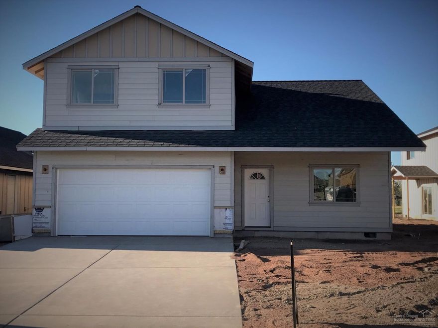 Willow plan in NW Redmond w/2 car garage. Open plan w/spacious kitchen, bar seating, huge great room w/Gas fireplace. Kitchen features corner pantry, Is Shaker style Knotty Alder cabinets w/crown molding & Quartz slab counters. Stainless appliances, gas range. Wood laminate flooring throughout main level. Main Level Master Ste w/massive walk in closet. Upstairs Loft area flex space, additional bedrooms & laundry, + full bath. High efficiency Gas Furnace, & A/C! Visit model@ 1924 NW Larch Wed-Sun