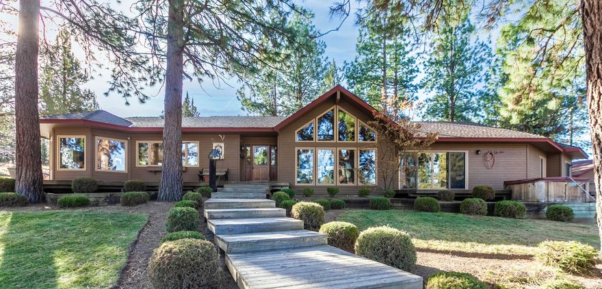 Come home to 20 acres of peace & privacy, yet minutes to town! You cannot see a single neighbor from your immaculate & beautifully updated single-level retreat in the pines! Relax on decks& patios or gaze from the many large windows flooding your home with natural light. Gourmet kitchen, huge dining space and great room feature natural wood ceilings, beams, vaults & windows on all sides to sync with the natural rhythm of the forest & seasons. Separation of 3 light filled bedrooms and 3 full bathrooms. Also find a separate office or TV room. Home includes many built-ins and storage & beautiful gas fireplace. Kitchen & bathrooms all updated, newer furnace, heat pump & water heater. PLUS! Sep 3000 sf garage/RV/rec storage with GUEST QUARTERS & huge craft room. A 2nd barn/garage and covered parking area or hay storage. The full 20ac is fenced and the pastures & pond are almost completely cross-fenced with underground irrigation. This property can easily accommodate animals. Full RV hookups