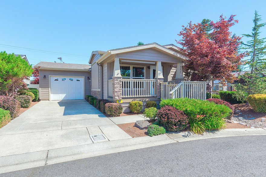 Located in the wonderful city of Grants Pass, Westlake Village is a premier 55+ community designed for comfort, connection, and carefree living! This beautifully maintained 1,275 sq. ft. home features a bright, open kitchen with ample cabinetry and a convenient breakfast bar, perfect for casual dining or entertaining. The living room, with vaulted ceiling, is filled with natural light from expansive windows, creating a warm and inviting atmosphere. Primary suite is spacious and offers a generous bathroom with a large tile shower and abundant closet space for all your needs. A one car garage adds convenience, while the gated, meticulously landscaped park offers peace of mind and stunning surroundings. Come enjoy the best of 55+ living — secure community, stylish home, and surrounded by beauty! You'll love it here!