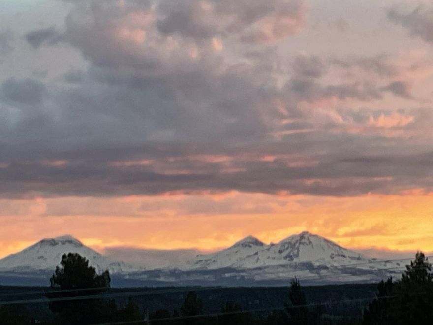 Standing on the deck of this Northwest style home you see Mt. Hood to Mt. Bachelor along with truly unbelievable sunsets. Lots of windows allowing a light & bright interior. 3bed/3bath, plus office. Great room with vaulted ceilings and a tall rock fireplace. Spacious kitchen w/granite countertops. Dining area. Hickory cabinets & built-ins throughout. There is a mini suite on the top floor w/full bath. Main floor has a guest bedroom, office & full bath. Bonus room & updated master suite w/enclosed screen porch is located downstairs. The interior and exterior were recently painted. New roof in 2021. Newly stained deck. New furnace 2022. Ductwork recently cleaned. This 4.5 acre property offers 2+ acre fenced pasture with loafing shed & hose bibs for horses. Terraced landscaping. $30k in boulders. Shop w/large doors, art studio, open bays for parking equipment & toys. RV storage w/parking & full hook-ups. Buyer can talk with county about the possibility of an ADU. New asphalt driveway.