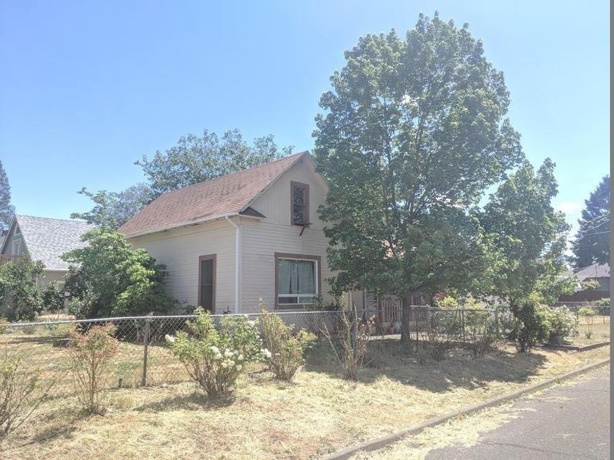 Cash only. 1396 sq. ft home with 3/2 baths on .18 acre corner lot. Large living room, master is on the first floor. Possible for multi-homes but check with the City fo Central Point. There is no foundation since home was built in 1900.