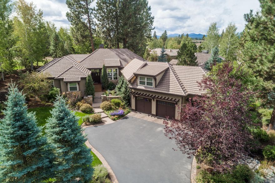 Broken Top Beauty! Enter through the charming courtyard into this warm & comfortable home & experience the perfect blend of quality craftsmanship & thoughtful design. SINGLE LEVEL living, w/ large master suite & 4 other bedrooms on the main level & a cozy den/office upstairs. Beautiful cherry hardwood floors, a see-thru fireplace & plentiful windows grace the open floor plan. Impressive chef's kitchen features a large island, embossed recessed ceiling, Jenn Air stainless steel appliances, walk-in pantry, wine frig & built-ins. Enjoy entertaining or relaxing on the delightful paver terrace in the back, offering privacy & complete w/a pergola, soothing water feature, decorative wrought iron fence, lush landscaping & lovely views of the treed common area/ green belt. Oversized 3 car garage w/separate workshop/project room. Lots of storage. Enjoy miles of hiking & biking trails, the Clubhouse restaurant & w/ membership: golf, tennis/pickleball, pool & fitness center. What a lifestyle!