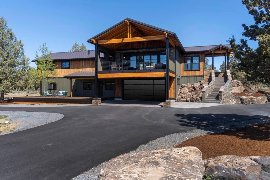 Designed for entertaining. The wide-open floor plan brings the outdoors in through a gliding glass panel wall from the great room to an expansive covered balcony with jaw dropping Cascade mountain views! The chef's kitchen features Quartz and Granite, Thermador 5 burner cook top w/pot fill, double wall ovens, wet bar w/sink, built-in Miele coffee/espresso, wine/beverage center, and ice maker. Such attention to detail, quality of construction and finishes are rarely found. JELD-WEN windows frame the views, custom FP mantel, iron detail and railings, European oak hardwood, natural stone tile (heated in bathrooms), dual head tile shower, California closet systems, stairway w/heated concrete steps and auto lighting are just a few. The primary bedroom is privately situated with 2 additional bedrooms, kitchen, bath, flex space and 2nd laundry downstairs. Lower level can be locked off for separate living/guest space. The easily maintained 2.49 ac. boasts a 28'x28' shop, RV pad & storage shed.