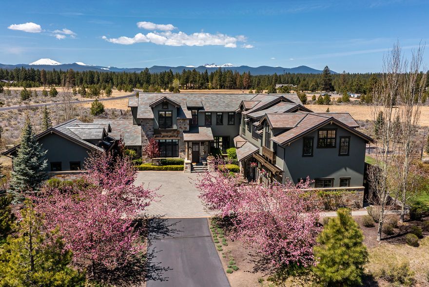 Traditional elegance and an architectural masterpiece in the heart of Bend's Westside! Situated on a premier 10 ACRE LOT in the exclusive community of The Highlands, this exquisite custom home offers unobstructed Cascade Mountain views and an unparalleled, private setting. Chef's kitchen w/solid surface counters, extensive working isl, delightful breakfast rm and a butler's pantry like no other. Kitchen opens to light-filled family rm w/stunning beam work, wood burn fp w/carved limestone surround and phenomenal mountain views. Formal Dining features french doors leading to one of multiple patios, blending indoor/outdoor living seamlessly. Entertain in the expansive formal living rm w/coffered ceilings, gas fp and separate bar. Private main level office+ add'l main level office. Upstairs: Primary Suite with spa-like bath and timeless marble finishes. 4 add'l en suite BR and bonus rm. 4 car garage. An outdoor enthusiast's dream location and moments from schools and Westside amenities.