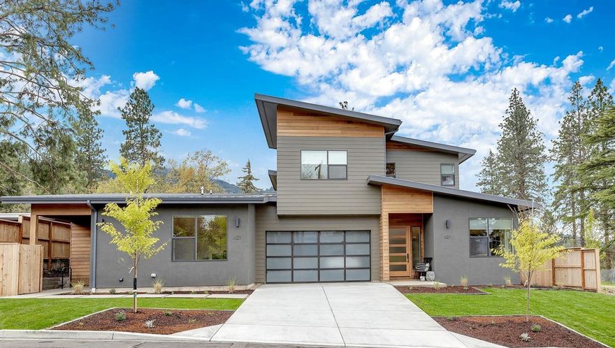 2018 contemporary stunner with tasteful high-end features throughout. A pitched metal roof, simple lines & a mix of materials give this home stylish curb appeal. Interior features include main floor master suite, expansive living/dining spaces off the island kitchen with ample counters, custom cabinets & tile work + loads of storage. Walnut floors & doors with expansive ceilings are just a sample of the finery that encompass this home along with rows of large windows that bring in the light & luxury of indoor-outdoor living. Clerestory windows illuminate the living room below & highlight 2 add. generously sized bedrooms. Private office, views of the mountains from spacious patios, raised bed gardens & large studio/storage space make this a dream to live in. The fully self-contained 2nd unit boasts a full kitchen, two bedrooms and private separate entry. Main house has 4 bedrooms, 3 baths, 2973 SF. Legal second dwelling with fireplace 773 SF of living perfect for Ashland living.