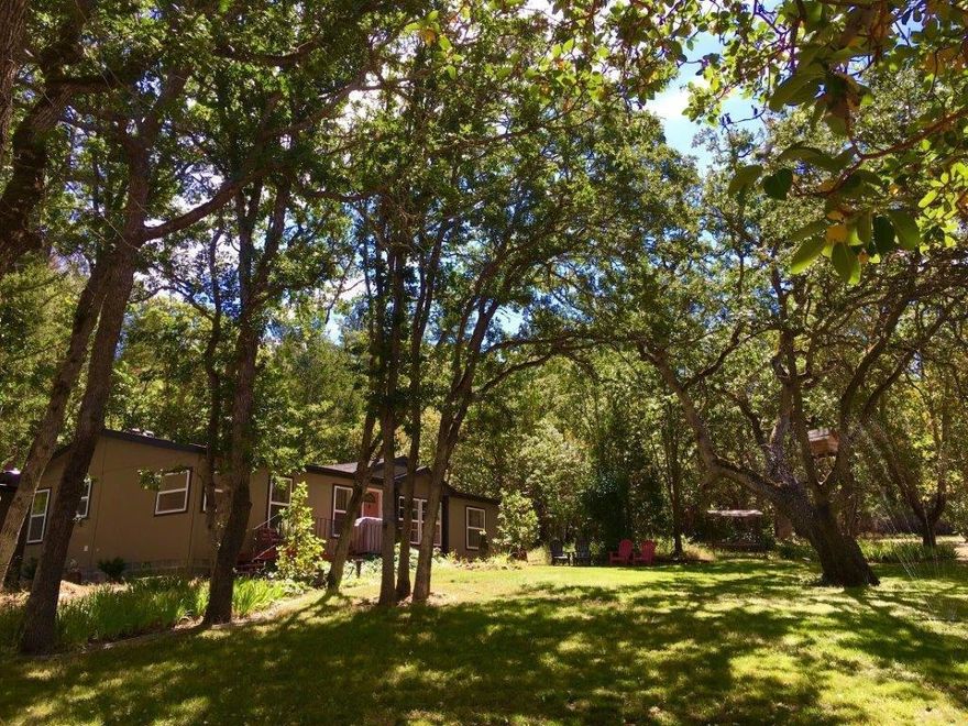 This wonderful country home is an ABSOLUTE MUST SEE if you're in the market for a conveniently located 1.5 acre flat & usable lot. The home sits far back off the private road. Enjoy the breathtaking views from your front deck. This spacious home has been tastefully updated & remodeled to give it the ambience & comfort of a beautiful custom home! This home boasts attractive chestnut flooring, new light fixtures & a split floor plan. This home has been freshly painted w/ warm & inviting colors. All appliances are newer including the washer and dryer. Bathrooms are spacious & the master bath has a large soaking tub. Outside you will find an attached bunk house & an 8'X 20' shop. There is also a metal storage building. There is a good producing well along w/ a 2000 gal holding tank, a water softener system, & a new pressure tank, per seller. The roof and skylights are only 3 yrs old. There is an amazing private & peaceful back patio which is completely fenced for your quiet enjoyment.