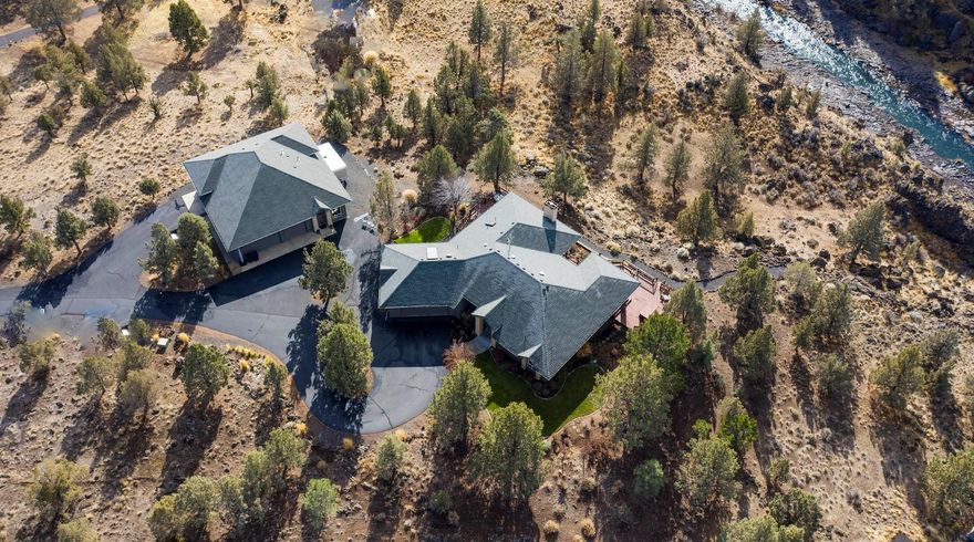 Rare River Front Property with stunning Mountain Views. Find serenity in this captivating 2695sqft Estate located behind the gates of Odin Falls in Redmond. Open concept and attention to detail finishes with vaulted ceiling, built in cabinetry rock wall encompassing a wood burning fireplace and so much more. 
Tile and Cork floors, granite countertops and beautiful glass tile backsplash. 
Recreation and relaxation meet at this scenic and enchanting property. 
Ample space for home office with separate guest suite/bonus area complete with bar and full bathroom and additional finished basement with separate entrance perfect for crafting or guest suite.  Bring your toys and park in the additional 3 car garage and RV bay.  RV bay includes full hook-ups and metal interior for easy cleaning and storage. This is a must see property with many hidden treasures.