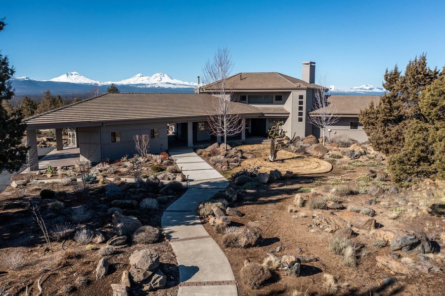 Privacy, tranquility & breathtaking Cascade views define this unique home. Nestled atop a knoll w/25 acres of mostly level land, this property never ceases to amaze. Offering 3 main level bedrooms (one en suite), a sunken living room w/wood burning fireplace, kitchen & dining-all w/large picture windows to capture the 7 peak views & ample natural light. Upstairs a primary bedroom suite oasis w/stunning 360* views & covered deck. True craftsmanship in the clear alder woodwork & paneling accents. Outside, enjoy the salt-water hot tub, year-round water feature, & gorgeously landscaped gardens allowing for seamless flow w/natural surroundings. Enjoy morning coffee on the sun-drenched front porch, afternoons on the patio w/stunning sunsets & evening stargazing. Driveway is fully paved from street w/shared gated entrance. Room for storage & toys w/3 garage spaces connected & a 2 car outbuilding.