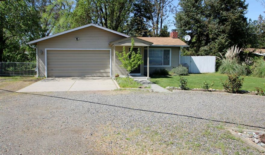 This home is all about classic Central Point charm, location, and versatility of the property. First, the home is very clean, well taken care of, and ready for YOU! The kitchen is adorable with glass cabinets and vintage style, with a peek-a-boo window looking out to the living areas. New water heater and dish washer. The property is pristine with the Rogue River irrigation ditch meeting up with Jackson Creek at one corner of the property. Irrigation rights are currently $239/yr, hand lines, pumps, and sprinklers remain so you can care for this .45 acre lot. A circular driveway gives you plenty of parking and gated RV parking so you can easy store your 'toys'. There is a 20x20 shop in the back with 110 and 220v electricity and a wood burning stove. This home really is a charmer in a great location! OWNER CARRY TERMS AVAILABLE!