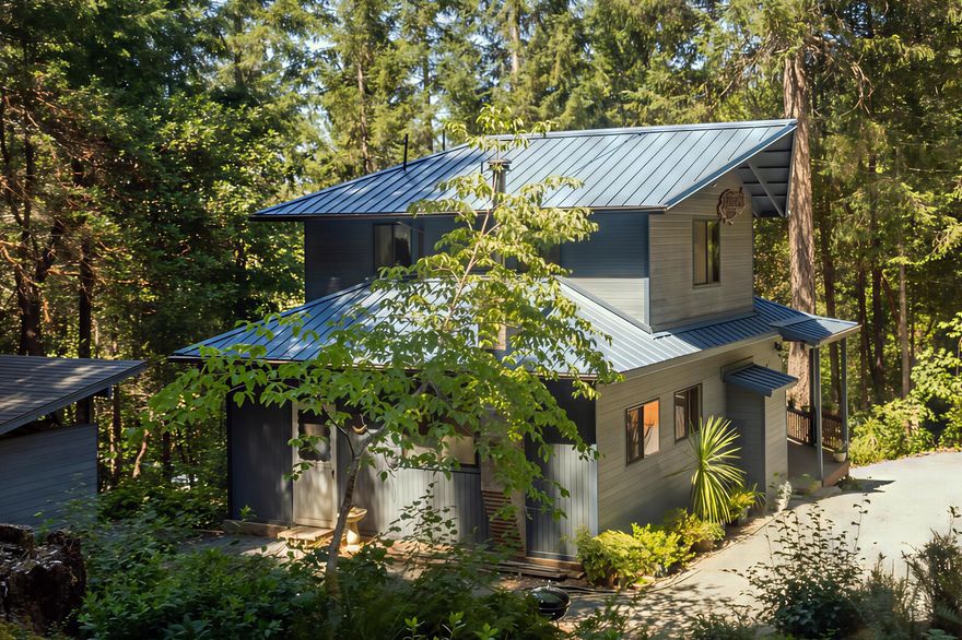 Discover mountain serenity on this private 5-acre property adjacent to over 2,000 acres of BLM. There's a park-like, manicured forest setting with marketable timber.  It's quiet, perfect for peaceful living. This contractor-owner-built home features fresh exterior paint, new laminate flooring, and a beautiful covered porch ideal for relaxing. The modern kitchen shines with tiled countertops, while the primary en suite offers a luxurious tiled shower and separate jetted tub. Other recent upgrades include a new sheet metal roof and a new hot water heater.  The well was logged at 10 gallons per minute when it was dug. There's a separate shop building that provides ample space for hobbies or storage.  Dog's haven: There's a cleverly designed dog kennel ready for your use.  Enjoy ultimate privacy and quiet on 4901 or double it!  There's an adjacent 5-acre vacant lot available for $75,000 to expand your oasis. Don't miss this rare opportunity, call for a showing today!