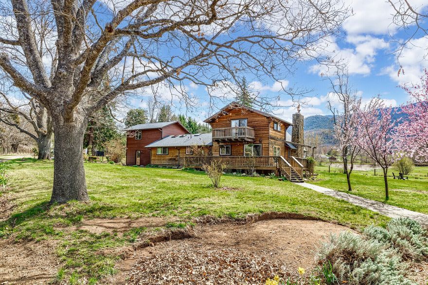 Nestled on 5 acres of serene land, this stunning property boasts a beautiful home with attached private guest quarters, two picturesque ponds, seasonal creek, views of the surrounding hills, and a barn. You'll be immediately struck by the tranquil beauty of the landscape. The home is a spacious and comfortable retreat. The living room features a cozy fireplace and large windows that offer stunning views. The spacious primary bedroom offers natural light and an ensuite bathroom with a walk-in shower. The guest quarters are equally impressive with a separate entrance, a full kitchen and a comfortable living area. Outside you'll find plenty of space to explore and enjoy. The barn is perfect for those with animals with ample space for storage, stalls, and more. A peaceful retreat or a place to entertain friends and family, this property has it all. The views alone are worth the price of admission, but the combination of comfort, privacy and natural beauty make this home one of a kind.