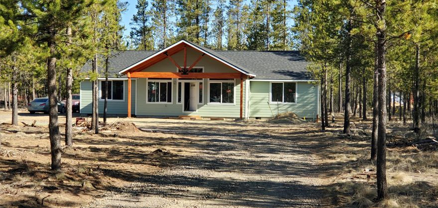 Located in beautiful Three Rivers South, this newly built home has 3 bedrooms, 2 bathrooms, an attached 2-car garage, and sits on a little over 1/2 acre. Surrounded by beautiful trees on a flat lot, you'll enjoy a sense of privacy without feeling secluded. As you enter the home, you are struck with an abundance of natural lighting, an open floor plan and vaulted ceilings. The kitchen features granite counters, beautiful laminate flooring, and plenty of storage in the custom-painted cabinets with a darker gray showcasing the island. The large primary bedroom and en suite bath are located on one side of the house with nice separation from the other two bedrooms on the opposite side. This home is close to all that Central Oregon has to offer, being within thirty minutes of Mt. Bachelor, many lakes, the Big Deschutes, Little Deschutes, and Fall Rivers. This property is a must see and is not expected to last long. Professional and Drone Pictures coming 4/21.