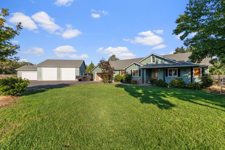 Mini farm property in a great location just outside Merlin.  You will fall in love with this modern craftsman style home with it's vaulted entry, stunning wood accents, hardwood floors and large closets.  You have a 3 car garage attached to the home and a huge 3 bay shop RV bays.  This shop has 30 amp, 50 amp and 220v wiring.  On the back of this shop/garage is an attached sheep/goat shed that also has electric ran to it.  2 acres are fenced and cross fenced to have pasture and garden/orchard area.   Close to Jump Off Joe Creek, the Rogue River and tons of other outdoor activities nearby.  You are also only 3-4 minutes from the interstate so quick and easy access back to civilization when you want it. Motivated sellers, bring your offers!