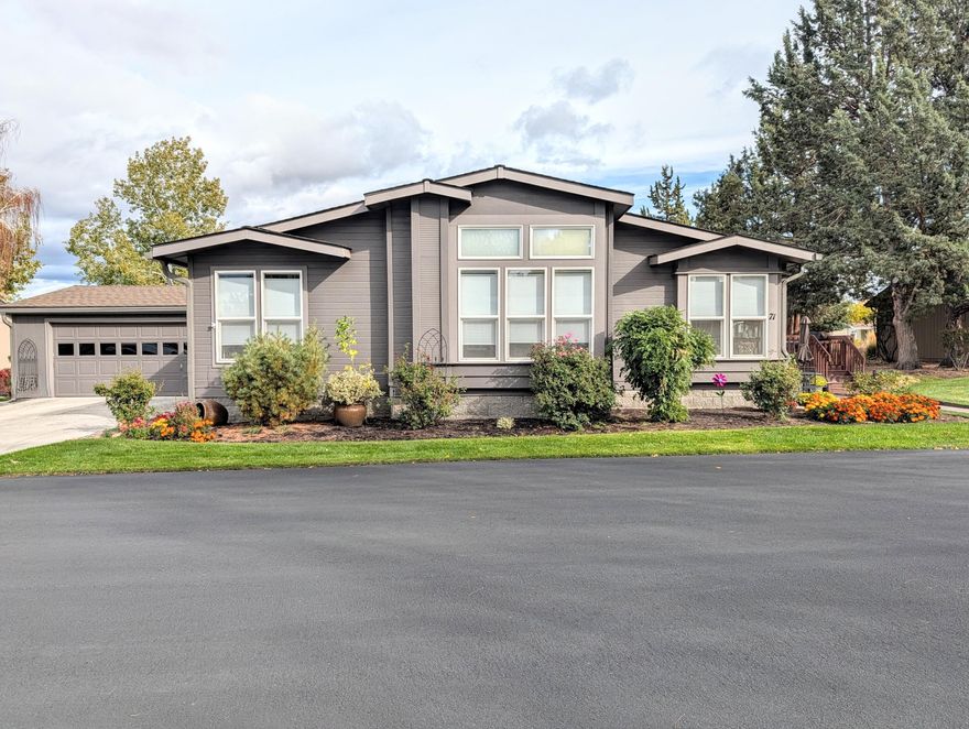 Beautiful, high-quality home in Bend's sought-after 55+ community, Snowberry Village. This spacious 2,363 sq ft home offers 3 bedrooms, including a main suite with two walk-in closets, lounge or office space and a large bath with walk-in shower, double vanity, and linen storage. Multiple living areas include a living room with gas stove, family room, and bright breakfast nook. The cook's kitchen features an island, wall oven, high-end gas range, refrigerator, and walk-in pantry. Dining area fits a large table and additional furnishings. Laundry room provides space for an extra refrigerator or freezer. Finished insulated garage with granite epoxy floor, sink, and room for two trucks. Large deck with retractable awning and lots of room for outdoor living. Many recent upgrades. Space rent $750/mo includes water, sewer, mowing, irrigation, debris pickup, snow removal, rec hall, and beautiful well-maintained grounds. RV storage available.