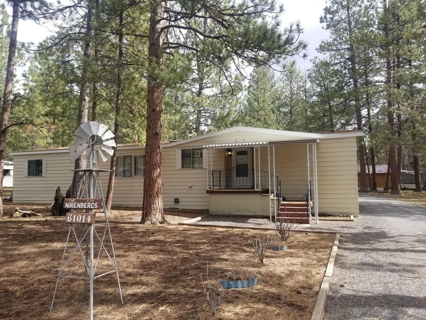 Enjoy living in nature, in a spacious  3 bedroom, 2 full bath, single level, privacy, close to Old Mill, downtown, trails, on a .33 acre level treed lot, Large 2 car garage detached with one tall door. RV parking with level gravel driveway. Bright kitchen with skylight and a Solar tube in  second bath. Sliding door leads to covered deck. Main level master with walk-in closet and on-suite bath Spacious dining area.
Get cozy next to freestanding gas fireplace new in 2012 or flip on the A/C. Tons of storage/closets, built-ins. One bathroom has a step-in shower,
New roof 2019. Manufactured home subdivision with Clubhouse and Pool. Small HOA fee.