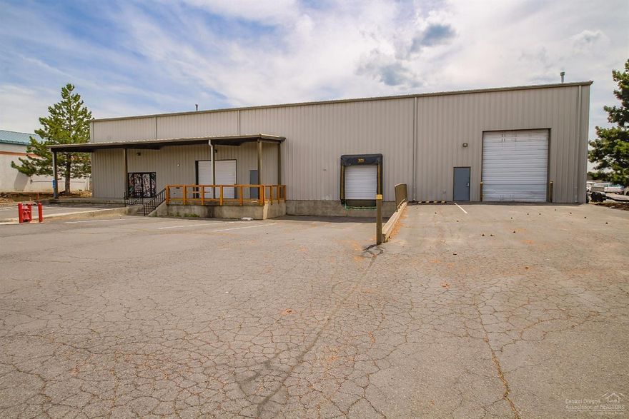 Quality industrial building with two dock high loading doors and one grade level 14' roll up door in the front. Additional 14' roll up door to back fenced storage area. Main floor has large air conditioned showroom area with two bathrooms. Upstairs is open area with forklift gate to lower warehouse and large air conditioned office. * Great Truck Access * Two Dock High with 10' Roll Up Doors * One Grade Level 14' Roll Up Door in Front and One in Back * Large Showroom/Office Area That is Air Conditioned *