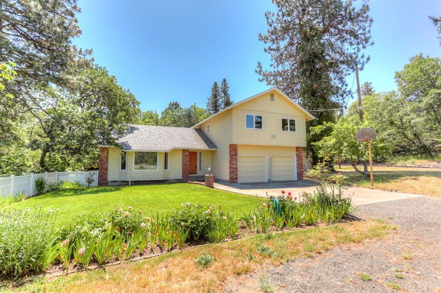 Classic upscale country living just minutes from downtown Ashland. Enjoy meals out on the back terrace overlooking the creek bed and beautiful grove of natural trees. Views from every room make living in this home a joy. Upgraded cabinets, counter-tops, tile bathroom floors add to the luxury while 3 full baths and separate living spaces add to the convenience. A huge shop and green house complete this serene picture.