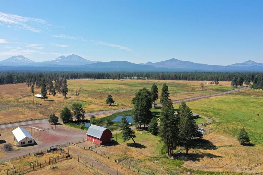 The historical Lazy Z Ranch is truly one of a kind. Just over 83 acres of picturesque land with stunning Cascade Mountain views. The property features a large single level ranch home with quality and craftsmanship throughout. The home has 5 bedrooms, 3 of them are master suites. A large greatroom that features a beautiful triple stone fireplace, a bar for entertaining, exposed beams and panoramic windows to capture the views. An open kitchen with a commercial refrigerator/freezer, a breakfast nook and a large built-in wood burning oven, grill and griddle. On the property there is a bunk/guest house, a 1930's Dutch Barn, RV garage, huge shop along with a hay shed, feed barn and storage sheds. The property has 59 acres of irrigation, along with a large pond. Private gated entry as well. Located just minutes from downtown Sisters. This is a rare opportunity to own a magnificent piece of Central Oregon history.