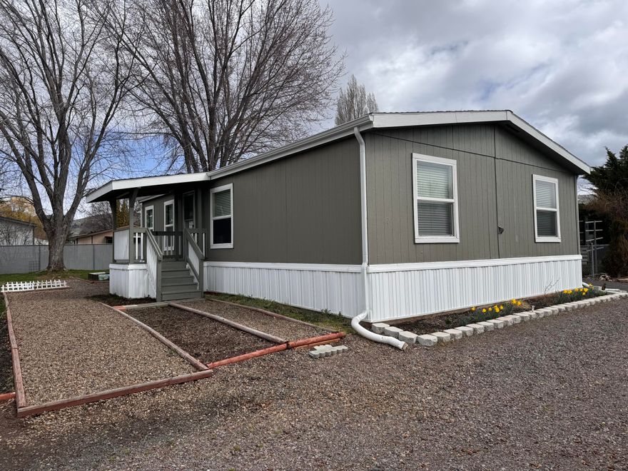 This three-bedroom, two-bath mobile home in Emerald Estates is in move in ready condition and  boasts a great floor plan and fresh paint throughout. It offers convenience with its proximity to schools, hospitals, stores, restaurants, and trails. Additionally, it features a large shed, carport, and a spacious yard, providing ample storage and outdoor space.