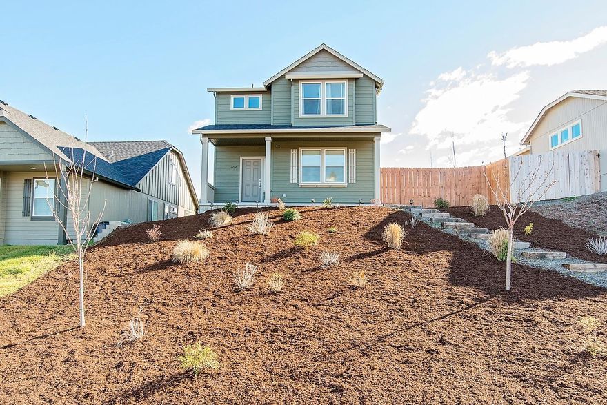 Built in 2017 this beautiful East Medford home is close to schools and services. With alley access to potential RV parking and an attached two car garage the professionally landscaped front yard gives the house great curb appeal. The entry on the main floor welcomes you to an expansive living room with a gas fireplace and built in shelving under a large alcove wired and ready to mount your flat screen TV. The large dining room adjoins a bright and comfortable kitchen with big pantry. The main floor is complete with an office (or small 4th bedroom) and a half bathroom. Upstairs you find the laundry room, two nice bedrooms with beautiful views, a full bathroom, and the private master suite which boasts a walk in closet and bathroom with large glass walk-in shower and dual sink vanity. Enjoy the low maintenance landscaped front yard and relaxing in the fenced grassy backyard with room for your four legged friends in a separate fenced dog run with nice built in dog door.