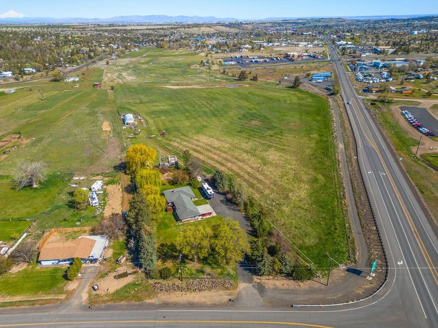 ATTENTION INVESTORS! 16.43 Ac of MUE with amazing location at the corner of Colfax and US 97 and hwy 26 with an average daily vehicle count of over 17,000. Annexed into the city of Madras and sewer main near the property line, This property is a huge opportunity. Property zoning MUE allows Large retail complex or Travel Center, or Hotel or light manufacturing or vehicle dealership or ? Total of 3,465sq.ft. and includes the following: 2,217sq.ft. house (5 bed 3 bath with mother in-law quarters), and 1,248sq.ft. Shop. Call your agent for the backup package and showing. Property is currently being used for residential. Main Zoning is MUE. Seller also has package deal available see listing 1820 US-97