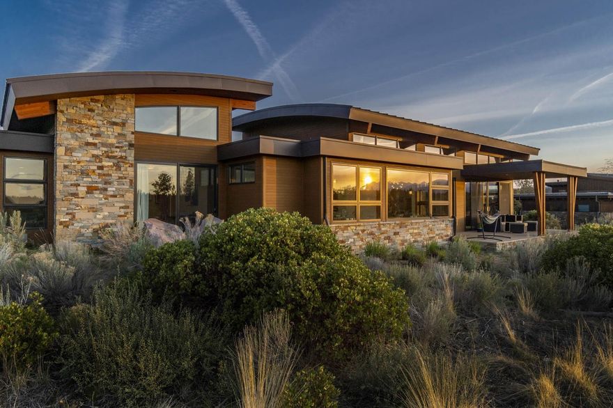 On this corner lot in the acclaimed Shevlin Commons, you are taken back by the breathtaking views of Bachelor, Jefferson, Sisters and the pristine setting of Shevlin Park. The outdoors are brought inside with a wall of windows spanning the length of the great room. The soaring and curved 18-ft ceilings allow the Cascades to be viewed from almost any angle. The open kitchen seamlessly blends styles w/concrete counters & Doug Fir cabs and is ideal for entertaining with kegerator, bev fridge and 2 islands. Glass doors off the kitchen lead to the private courtyard patio for easy indoor-outdoor entertaining. The owner's suite features its own private patio, a spa like bathroom with soaking tub, curb-less shower, double vanity with quartz counter tops and an expansive walk in closet. Today's buyers will love the 2 add'l guest beds (one en-suite), office, large bonus room, full guest bath and those who enjoy more privacy will love the attached but separate studio/4th en-suite bdrm.