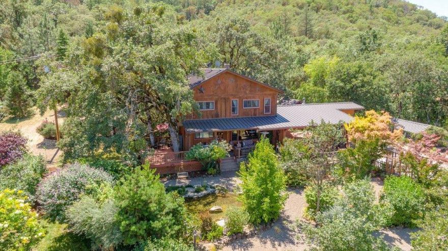 Location, Location, Location! The home and 28+ acre property offers views, pastures, and wooded hillside. Tucked away above Old Stage Road it is your own Oregon dream. As you enter the front yard there is fantastic landscaping, and a wonderful pond with a waterfall adding to the ambiance! The decks on the front of the home offer outdoor living, incredible views of the valley and city lights at night. 2376 square foot home with 4 bedrooms (one on the main level) and 3 bathrooms. Beautiful kitchen, dining area, and cozy living room in this great home! Mature landscaping really brings this property together. Above the home is a detached garage and a fabulous older building for what ever you need. There is even an old gold mine on the property! The land is great for many uses and is a true Southern Oregon gem!