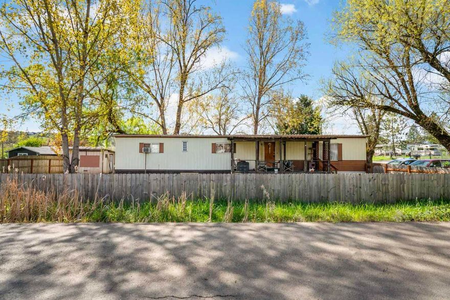 NOW VACANT - DON'T MISS YOUR OPPORTUNITY! Manufactured home on corner lot. Fenced property w/ mature shade trees & territorial view. Covered front deck is perfect for unwinding or enjoying your morning coffee. Inside, the living room has lots of natural light streaming through large windows. Attractive built-ins  enhance the functionality of the room. Dining area features sliders leading to the outdoors, seamlessly blending indoor & outdoor living. Kitchen has lots of cupboard space. Primary bedroom is complete with a private bathroom for added comfort & privacy. Two additional bedrooms & a full bathroom will accommodate family & guests. The laundry room has an exterior entry to the carport, doubling as a convenient mudroom for seamless transitions between indoor & outdoor activities. Located in a desirable area, this home is just moments away from a variety of amenities including restaurants, vineyards, and the scenic South Umpqua River. Easy access to Hwy 99 for easy commute.