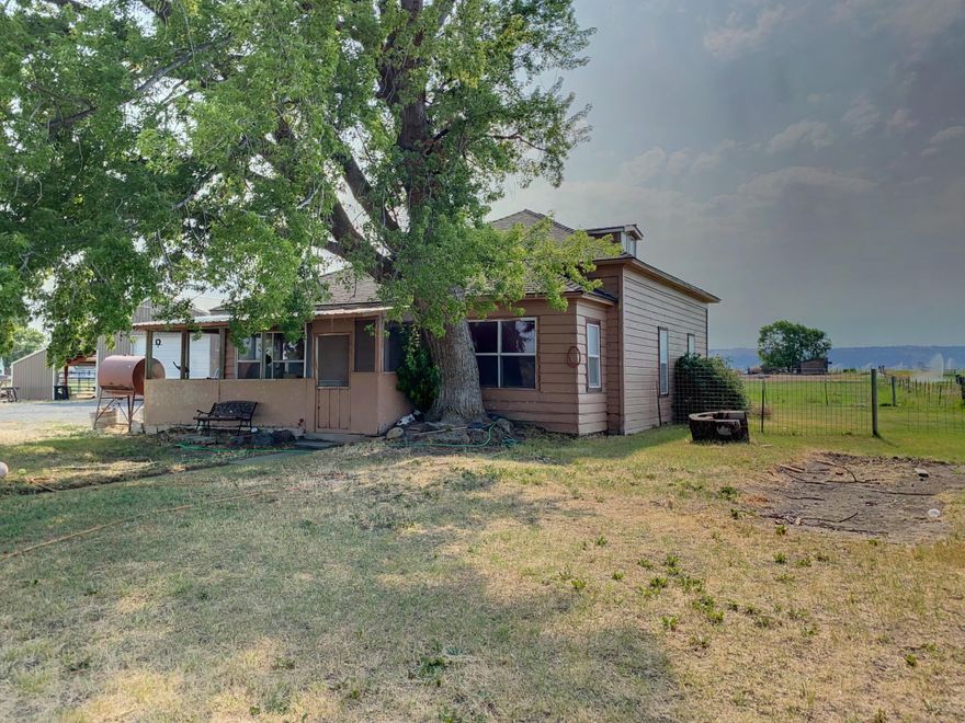 Great Location with 5.6 acres of Irrigation.  The home features 3 bedrooms 1 bath, updated kitchen with laminate flooring and updated bathroom. Large 30x40 shop with attached 30x24 lean to. Property is completely fenced and has a nice size arena. Enjoy the beautiful view surrounded by farm ground.