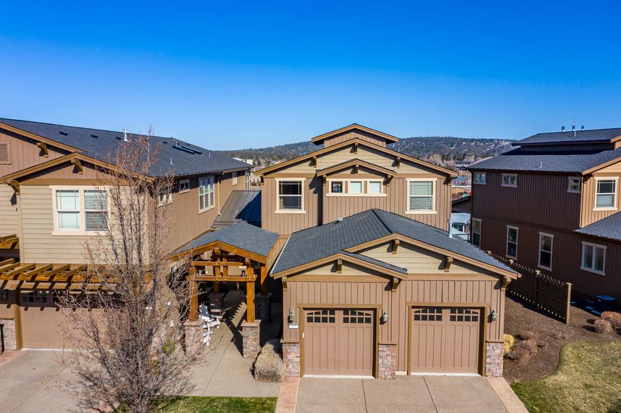 Beautiful townhome in The Bluffs is being sold by original owner.  Lightly lived in as a second home, and very well maintained—feels like new. Unobstructed panoramic views of Cascade Mountain range, Deschutes River and the Old Mill District. Enjoy listening the Les Schwab Amphitheatre summer concerts from the comfort of your own balcony. Tastefully remodeled, upgrades include granite and marble countertops, beautiful tile backsplashes, hardwood floors, light fixtures and crown molding throughout. Junior master suite on the main level, great room floor plan with spacious dining room and dry bar seating area with a wine cooler. Upstairs is a large loft area, spacious master suite with huge walk-in closet and luxurious en suite bathroom.  Both the upstairs loft and master have doors opening onto the large upstairs balcony. Carefree living at its best. A must see!