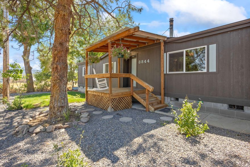 At last a slice of heaven...within spitting distance from Prineville. A country 1,782 sq ft doublewide on a permanent foundation w/all new double pane windows, new siding, freshly painted, and new deck w/fan. The freshly landscaped yard was planned for low maintenance & to create curb appeal. The inside of this 3 bedroom, 2 bath home is move-in ready w/new vinyl flooring, new sinks, toilets, separate laundry room and a time capsule kitchen. Storage is so plentiful that you can hide your hoarding habit. The furnace has been sucked clean & the septic pumped and dumped. Shared well w/great pressure. Large .30 acre lot is park-like w/room for 4H animals, chickens & garden. Two small outbuildings are ready to hold wood, use as a potting shed, or chicken coop, whatever your hearts desire. The only thing missing is you and your family to make
it your home.