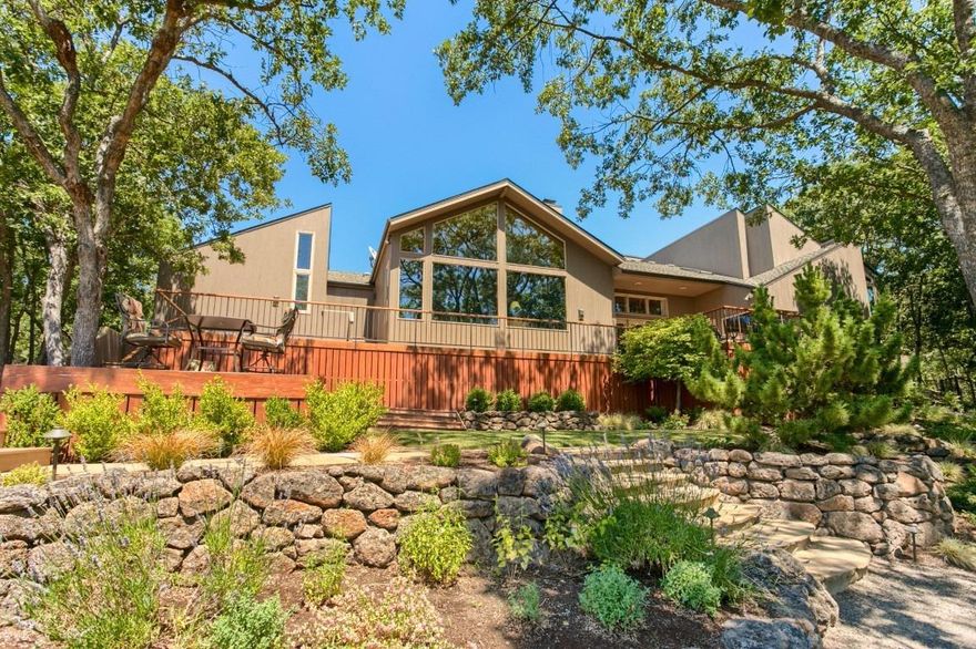 A beautiful East Medford hills home with amazing views, remodeled and restyled home with exquisite taste and design. There are 6.51 acres of room and privacy, just minutes from RRMC and downtown. The home features newly refinished floors, new paint, redone upgraded kitchen with Cherrywood cabinets, StoneTech granite counters, Hubberton Forge lighting and fixtures, plus living room floor to ceiling windows to capture the valley views. It is an open floor plan with vaulted ceilings, perfect for entertaining with 1250 sq ft of TimberTech decks off of the main living area, dining room and kitchen. The master suite has both luxury and privacy with an onyx, back-lit fireplace, 14ft ceilings, steam shower and quartz counters and onyx in the shower. The two main floor bedrooms are large and all boast 14ft vaulted ceilings, and there is a theatre room in the daylight basement with sound proofing insulation. There is also a 1700 sq ft shop, finished with bath, office, and loft area.