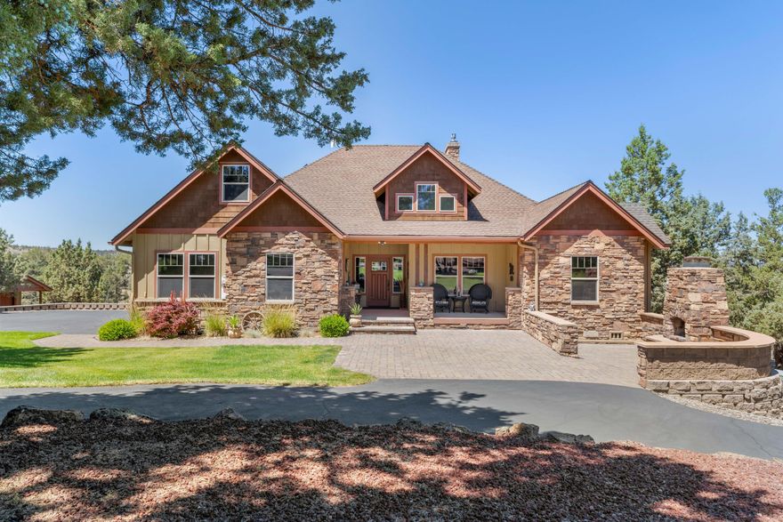 Perched on over 8 acres with panoramic Cascade Mountain views over the ridge, this custom luxury home blends elegance and functionality. Custom cabinetry, hand-scraped engineered hardwood floors, and vaulted ceilings elevate every space. Chef's kitchen boasts SS appliances, double wall ovens, large storage island, and flows seamlessly to the living area w/ a stacked-stone fireplace and wet bar! Main-level primary suite feat. dual walk-in closets, dual vanities, and a custom-tiled shower! Bonus room could be 4th bedroom! Walk-able crawlspace. Attached garage w/ storage room, 800+ sqft finished shop. Asphalt driveway, paver patio & RV pad w/ hookups. Outdoor fireplace. Stunning landscaping. Lower part of the property has endless possibilities - horse arena, barn or addt'l shop. This property cannot be described in 1,000 characters or less so see the attached features list for so much more!