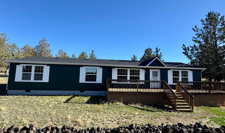 Extremely peaceful & private country setting offering stunning sunsets just minutes from Prineville! Discover a perfect blend of comfort, privacy, & practicality in this well-maintained home sitting on 10 fenced low-maintenance acres. Fresh interior & exterior paint, new hot water heater, & brand-new roof means all the hard work is done—just move in & enjoy! Step inside to find vaulted ceilings, hardwood floors, all appliances included, & a spacious kitchen w/ample storage and island seating—ideal for entertaining or everyday living. Large windows frame the beautiful views, while the wraparound deck invites you to relax & soak in the serene, tree-studded surroundings. Bring your hobbies & projects—this property features multiple outbuildings, including a great versatile shop w/concrete floors, & detached garage. Enjoy peace, privacy, & room to roam. The included 5-acre parcel to the West is a separate tax lot & is buildable, perfect for family compounds or a bonus investment property