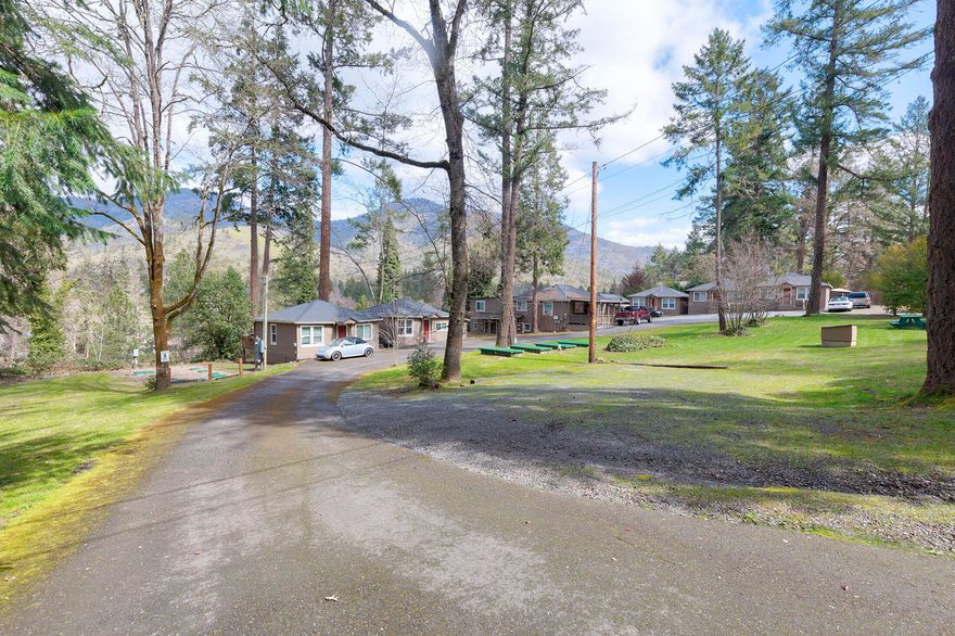 Attention investors!  Welcome to The Cottages on the Rogue!  This 9 unit property features a 3 bedroom 1 bath home great for potential manager quarters with basement along with 8 cottages that include 6 - one bed one bath, 1 - two bedroom one bath and one studio. Several units overlook the famous Rogue River with exterior decks and beautiful mountain views.  Capital improvements  include roofs, windows, natural gas heating, and completely revamped septic system.  Common area up front is great for entertaining. Units have had long term tenants, some as many as 20 years! Owner will Carry with acceptable terms! Centrally located between Grants Pass and Rogue River.  Call to schedule your tour today!