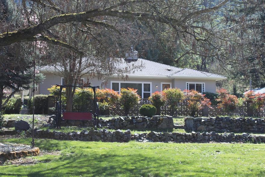 Beautifully maintained 2 bed 3 bath home in park like setting. Mature landscaping, sprinkler system, 2 wells, RV parking, attached 2 car garage, detached garage/workshop, all just minutes away from I-5 on ramp and the City of Rogue River! Need additional storage? Home is on just over 1 acre, has a walk in basement, additional storage in the attic and adjacent .46 acre lot is for sale. Relax to the magnificent views of Rogue River on your drive home.