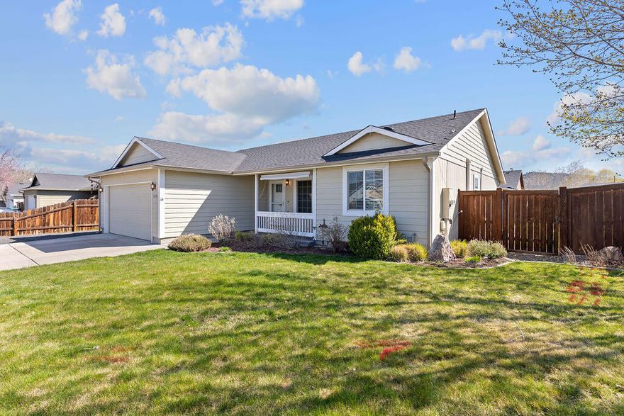 This delightful single level home, located on a corner lot, features a fenced backyard, perfect for outdoor activities. Inside, you'll find 2 cozy bedrooms and a bathroom on one side of the home. The primary bedroom and bath are privately located on the other side. Recent updates have added a touch of modern comfort, including a gas fireplace for cozy evenings, charming wainscoting in the primary bedroom and sleek laminate flooring. The home is equipped with mini split heating and cooling systems, ensuring comfort for all seasons. A covered porch, behind the dining French doors, offers a welcoming space for relaxation or entertaining guests. For those with recreational vehicles or boats, there's convenient side parking available, along with ample storage space in the three sheds and carport.