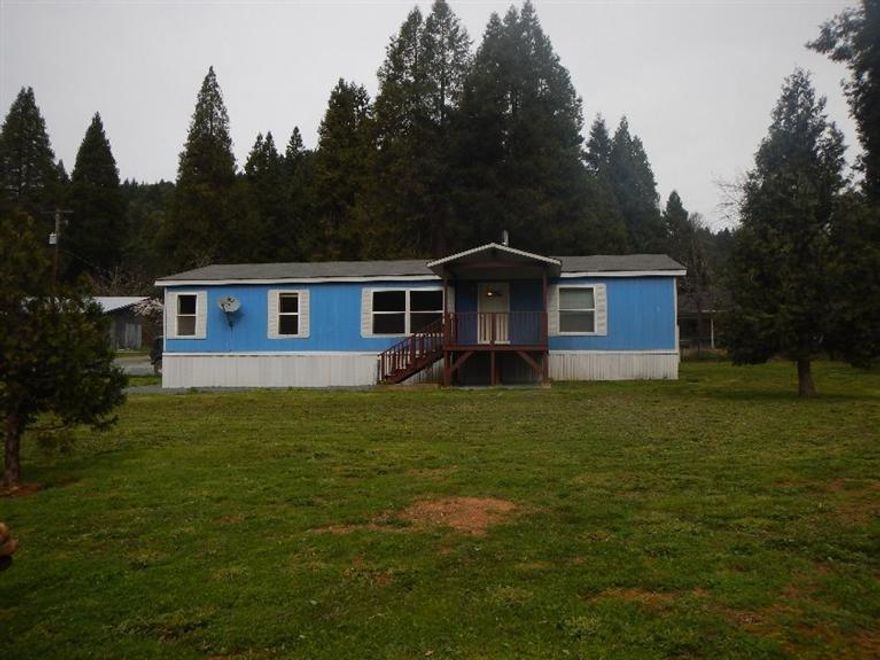 Newly updated 1512 sf Manufactured 3 bedroom two bath features a large open kitchen and spacious living area with a certified wood stove. New interior paint, laminate floors and new sinks. A new roof and septic system were installed in 2008. Detached 20x20 garage. Room for your R.V. with hookups. You'll enjoy the beautiful views of the mountains from your porch. The property is close to town and Wolf Creek County Park.