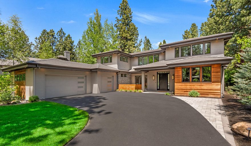 A confluence of modern and clean styling, luxurious finishes, and a highly functional floor plan, this 2016-built home delivers this rare combination of features with perfection.  The expansive great room provides an inviting and spacious living area highlighted by the gourmet chef's kitchen with high end appliances.  Experience a seamless flow between outdoor and indoor living areas with the accordion glass wall to the rear of the home which leads to the covered patio, outdoor kitchen and private outdoor space complete with water feature, fire pit, and patio designed for entertaining.  Two primary suites can be found on the ground floor, each with their own serene garden view.  Additionally, the main level has two private office spaces, ideal for modern day work-from-home needs.  All of this within the desirable gated community of Broken Top, known for its championship golf course and amenities such as pickleball/tennis, swimming pool, and community lodge.