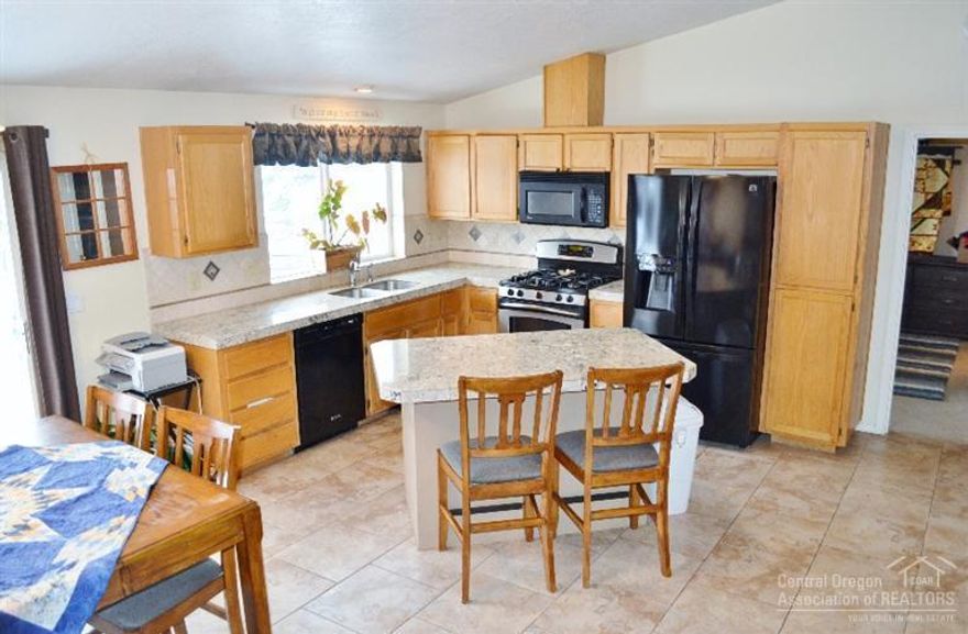 Charming 3 Bedroom 2 Bath home with large backyard in NE Bend. Open floor-plan, vaulted ceilings, tumbled travertine and granite throughout. Master bedroom with attached bathroom and walk-in closet. 0.24 Acre beautifully landscaped backyard, fully fenced with sprinkler system. RV potential. Don't miss your opportunity to be in this well kept home before the holidays.